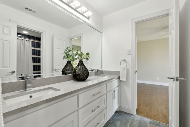 1105 Northpark Dr, Richardson, TX 75081 - bathroom featuring baseboards and double vanity