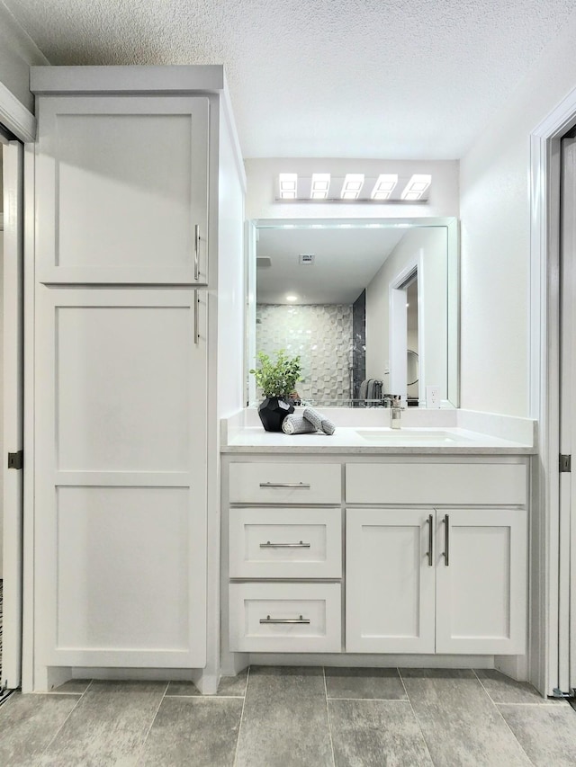 1105 Northpark Dr, Richardson, TX 75081 - bathroom featuring vanity and a textured ceiling