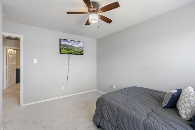 bedroom featuring baseboards, light colored carpet, and a ceiling fan