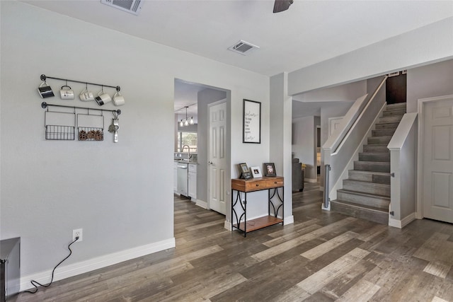 interior space with visible vents, stairs, baseboards, and wood finished floors