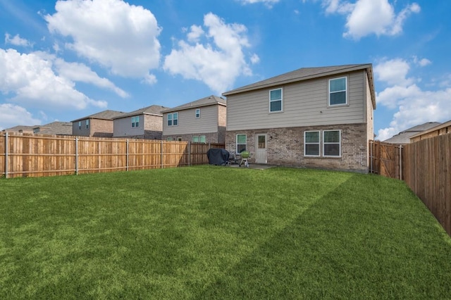 528 Lake Erie Dr, Princeton, TX 75407 - rear view of house featuring a patio area, brick siding, a fenced backyard, a residential view, and a yard