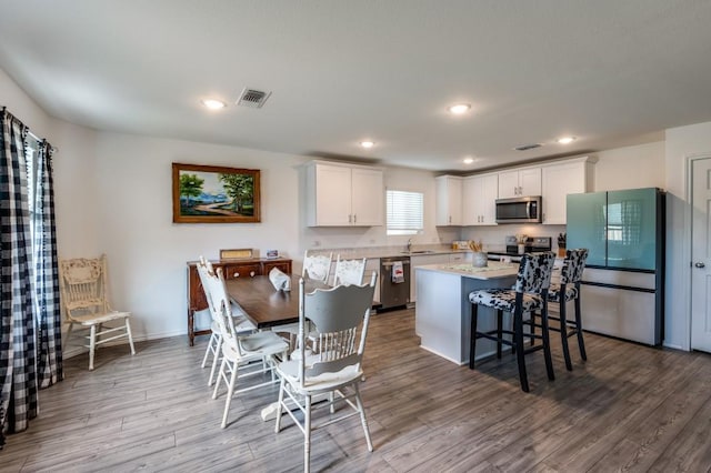 528 Lake Erie Dr, Princeton, TX 75407 - dining room with baseboards, visible vents, recessed lighting, and wood finished floors