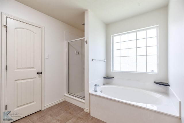 358 Sugarberry Ave, Abilene, TX 79602 - bathroom with a bath, a shower stall, and tile patterned floors