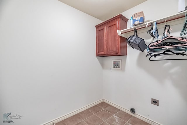 358 Sugarberry Ave, Abilene, TX 79602 - washroom featuring cabinet space, baseboards, electric dryer hookup, washer hookup, and light tile patterned flooring