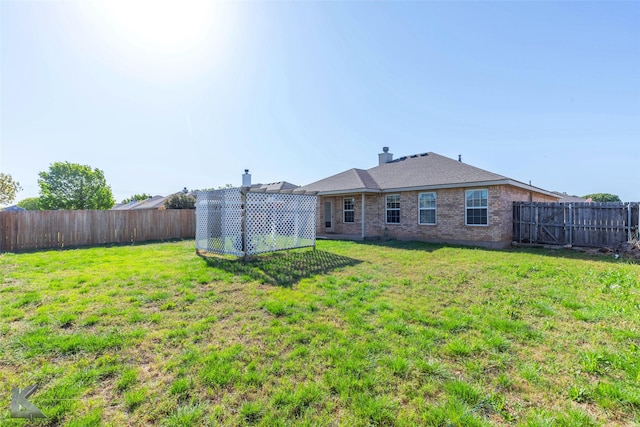358 Sugarberry Ave, Abilene, TX 79602 - back of house with a lawn, a chimney, a fenced backyard, and brick siding