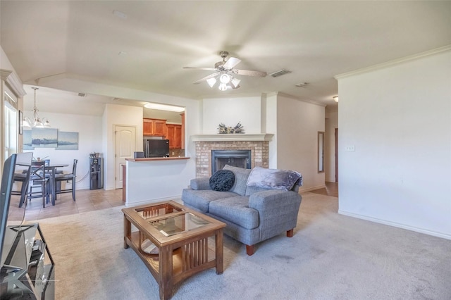 358 Sugarberry Ave, Abilene, TX 79602 - living area featuring ceiling fan with notable chandelier, a fireplace, light colored carpet, visible vents, and baseboards