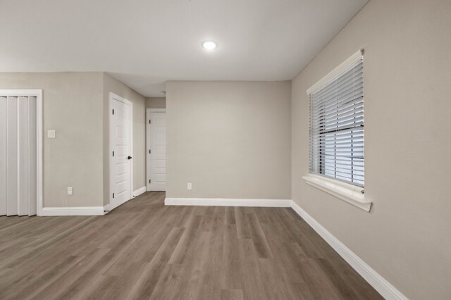 1010 Belew St, Irving, TX 75061 - empty room with baseboards and wood finished floors