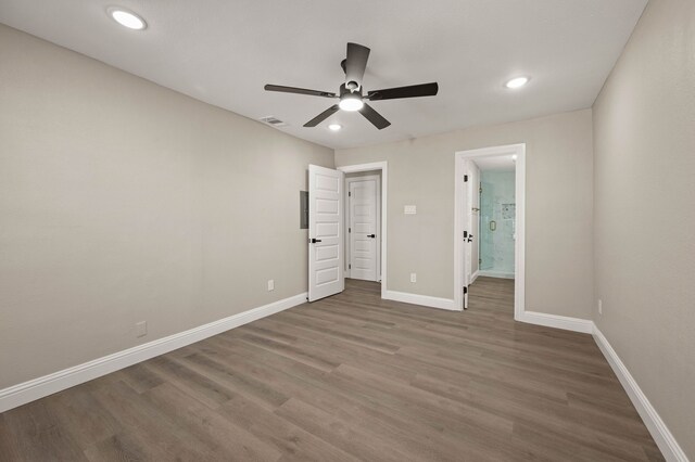 1010 Belew St, Irving, TX 75061 - unfurnished bedroom with recessed lighting, connected bathroom, baseboards, and wood finished floors