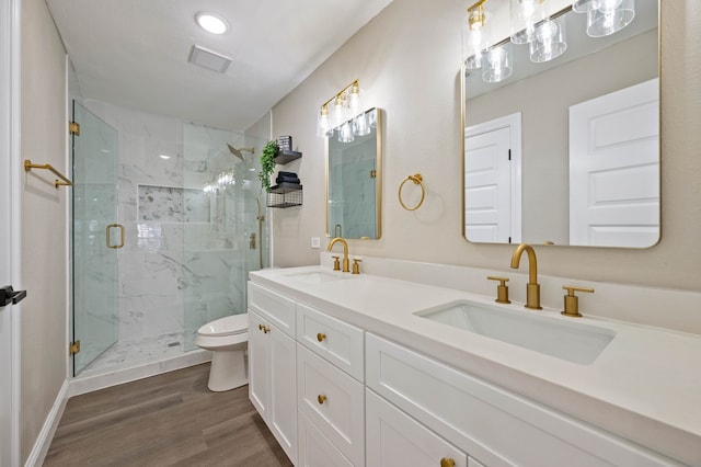 1010 Belew St, Irving, TX 75061 - bathroom with a marble finish shower, toilet, wood finished floors, and a sink