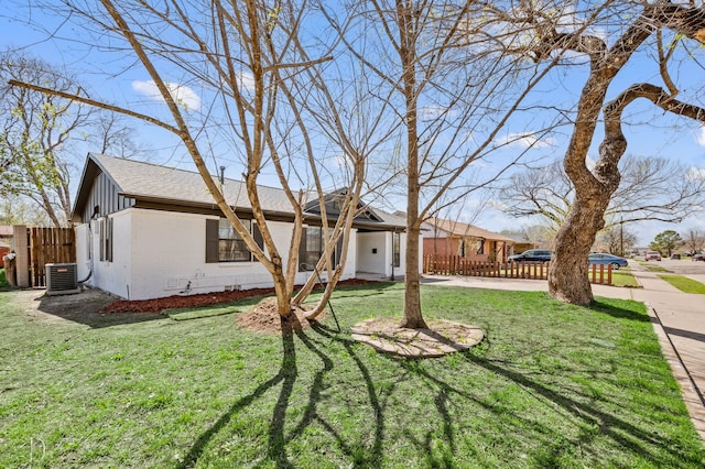 1010 Belew St, Irving, TX 75061 - view of front facade with a front yard, fence, central AC unit, and brick siding