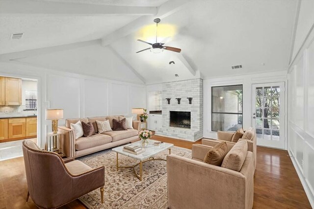 2616 Appledale Ln, Dallas, TX 75287 - living room with a decorative wall, ceiling fan, wood finished floors, and a brick fireplace