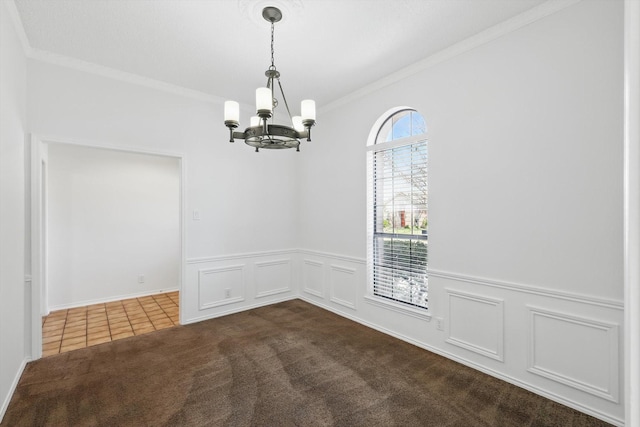 2616 Appledale Ln, Dallas, TX 75287 - empty room featuring a chandelier, crown molding, dark colored carpet, dark tile patterned flooring, and a wainscoted wall