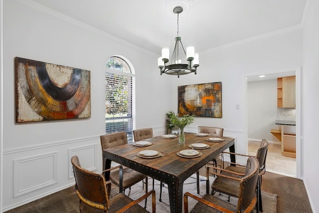 2616 Appledale Ln, Dallas, TX 75287 - dining area featuring a chandelier, crown molding, wainscoting, dark carpet, and a decorative wall