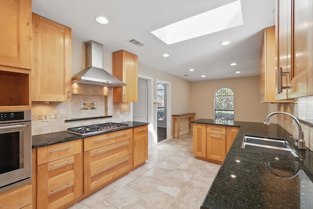 2616 Appledale Ln, Dallas, TX 75287 - kitchen featuring wall chimney range hood, a sink, appliances with stainless steel finishes, a skylight, and backsplash