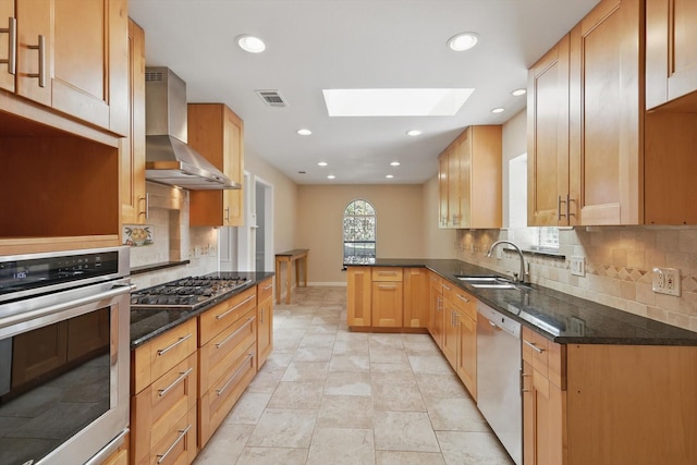 2616 Appledale Ln, Dallas, TX 75287 - kitchen featuring appliances with stainless steel finishes, wall chimney exhaust hood, a sink, a skylight, and decorative backsplash