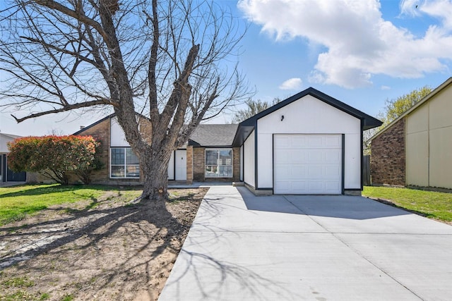 single story home featuring a garage, driveway, and brick siding