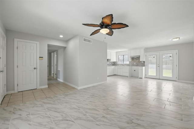 unfurnished living room with ceiling fan, french doors, baseboards, visible vents, and recessed lighting