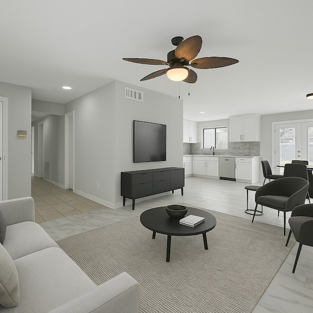 living area with baseboards, visible vents, recessed lighting, and ceiling fan
