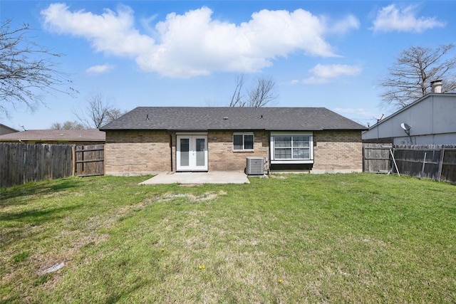 rear view of property with brick siding, french doors, a patio area, and central air condition unit