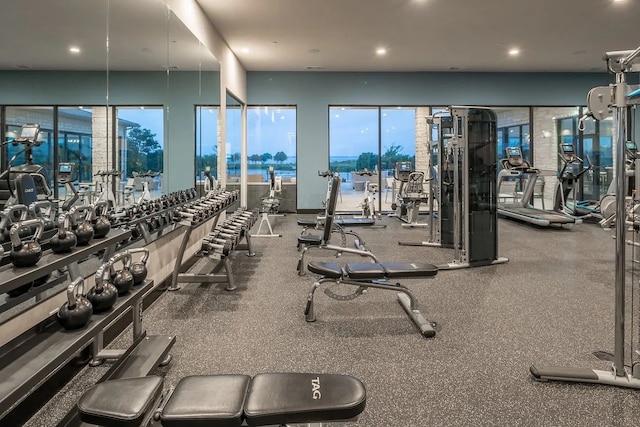 gym featuring recessed lighting and a water view