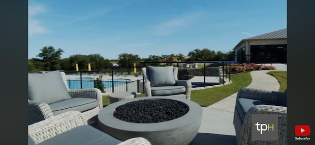 view of patio with an outdoor living space, a community pool, and fence