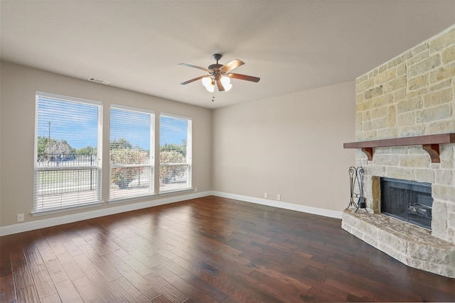 1305 Greenrock Ct, Midlothian, TX 76065 - unfurnished living room featuring ceiling fan, a fireplace, dark wood-type flooring, and baseboards