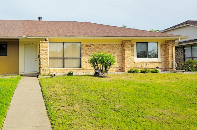 2224 Limestone Ln, Garland, TX 75040 - ranch-style home featuring a front lawn, brick siding, and a shingled roof