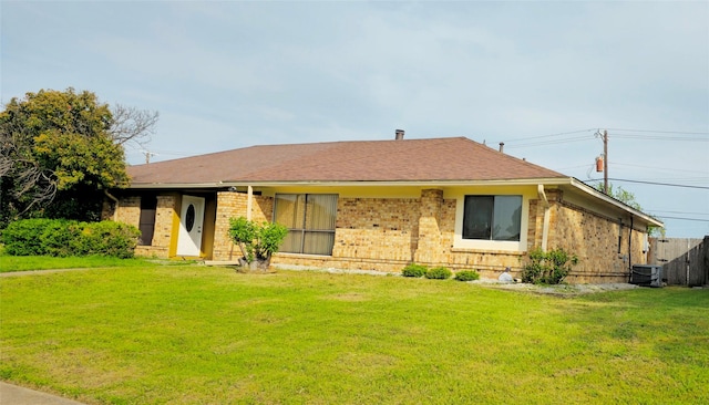 2224 Limestone Ln, Garland, TX 75040 - ranch-style house featuring brick siding, central AC, a front lawn, and fence