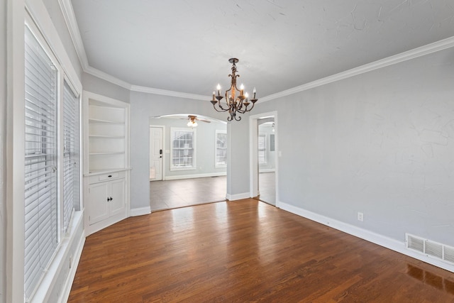 2508 Carnation Ave, Fort Worth, TX 76111 - unfurnished dining area featuring a chandelier, arched walkways, ornamental molding, wood finished floors, and baseboards