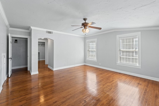 2508 Carnation Ave, Fort Worth, TX 76111 - unfurnished bedroom with arched walkways, hardwood / wood-style floors, baseboards, a textured ceiling, and a ceiling fan