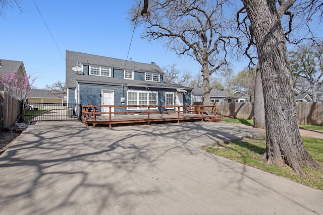 2508 Carnation Ave, Fort Worth, TX 76111 - back of property featuring a wooden deck, fence, and a chimney