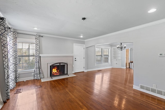 2508 Carnation Ave, Fort Worth, TX 76111 - unfurnished living room with a chandelier, a fireplace with flush hearth, baseboards, wood finished floors, and crown molding