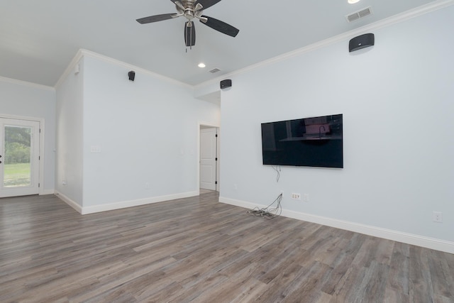 unfurnished living room with crown molding, wood finished floors, and baseboards