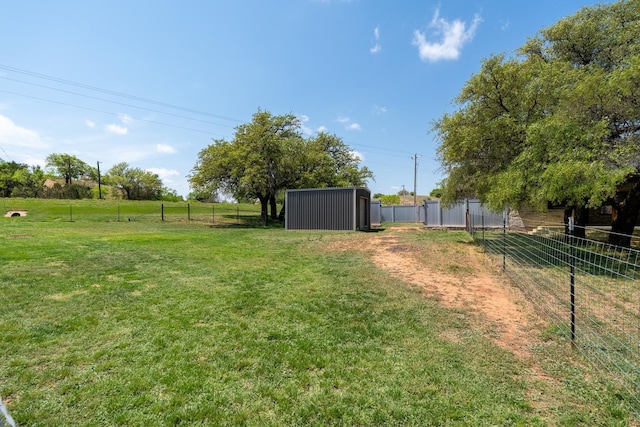view of yard featuring fence and an outdoor structure