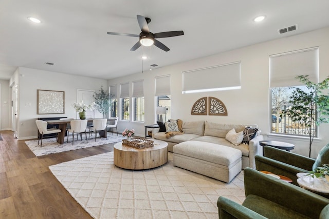 living area with wood finished floors, baseboards, visible vents, ceiling fan, and recessed lighting