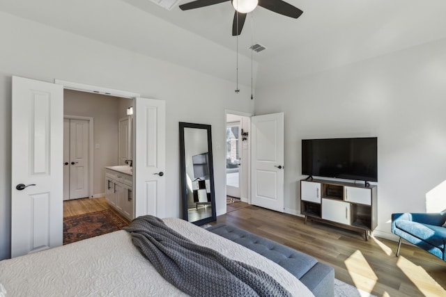bedroom featuring a ceiling fan, visible vents, baseboards, and wood finished floors