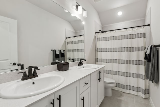 full bathroom featuring tile patterned floors, a sink, toilet, and double vanity