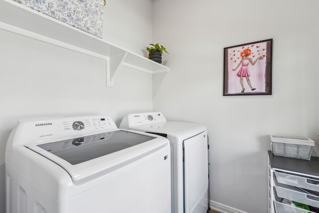 laundry room featuring baseboards, laundry area, and separate washer and dryer