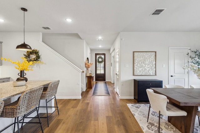 dining space featuring stairway, recessed lighting, baseboards, visible vents, and wood finished floors