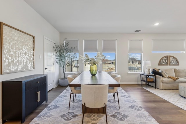 dining space featuring baseboards, visible vents, wood finished floors, and recessed lighting