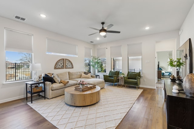 living area with ceiling fan, visible vents, recessed lighting, and wood finished floors
