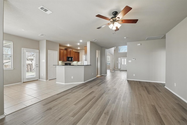 804 Starling Ln, Aubrey, TX 76227 - unfurnished living room with a ceiling fan, light wood-type flooring, and baseboards