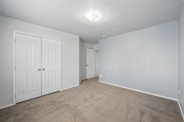 804 Starling Ln, Aubrey, TX 76227 - unfurnished bedroom featuring carpet floors, baseboards, a closet, and a textured ceiling
