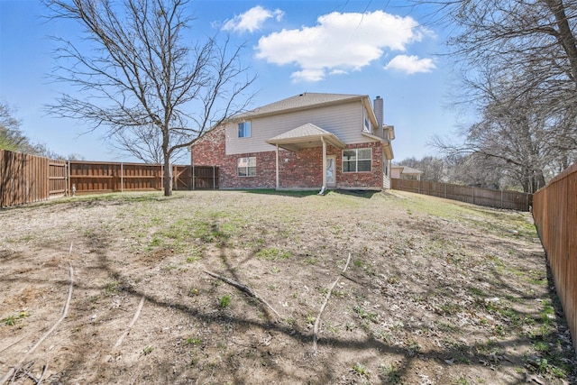 804 Starling Ln, Aubrey, TX 76227 - back of house featuring brick siding, a chimney, and a fenced backyard