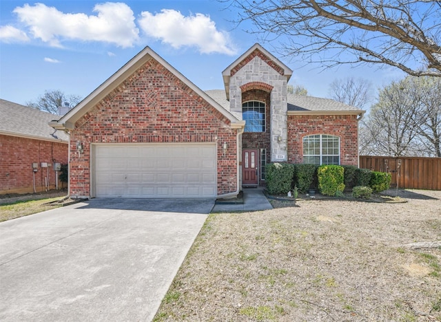 804 Starling Ln, Aubrey, TX 76227 - view of front facade featuring an attached garage, concrete driveway, brick siding, and stone siding