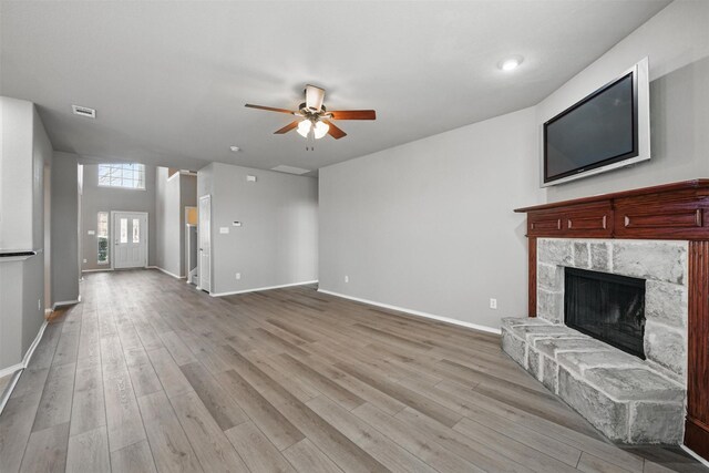 804 Starling Ln, Aubrey, TX 76227 - unfurnished living room with a fireplace, a ceiling fan, light wood finished floors, and baseboards