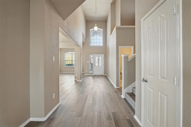 804 Starling Ln, Aubrey, TX 76227 - entryway with stairs, wood finished floors, a high ceiling, and baseboards
