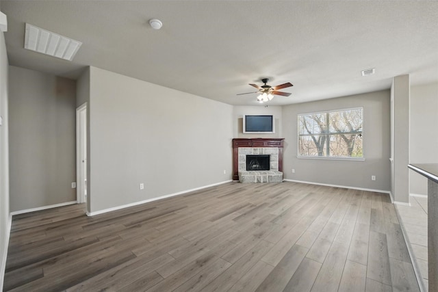 804 Starling Ln, Aubrey, TX 76227 - unfurnished living room with a ceiling fan, wood finished floors, baseboards, and a fireplace