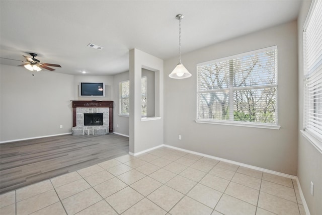 804 Starling Ln, Aubrey, TX 76227 - unfurnished living room with ceiling fan, a fireplace, baseboards, and light tile patterned floors