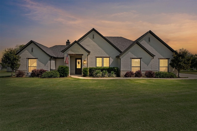 305 Scenic Creek Ct, Reno, TX 76020 - french country style house featuring a chimney, a lawn, brick siding, and a shingled roof